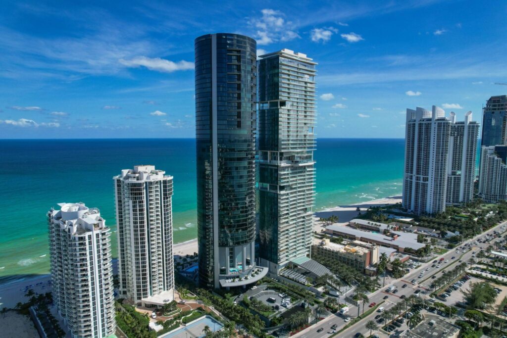 Beachfront property in Miami, Florida, showcasing sandy shores and clear blue waters under a bright sky.